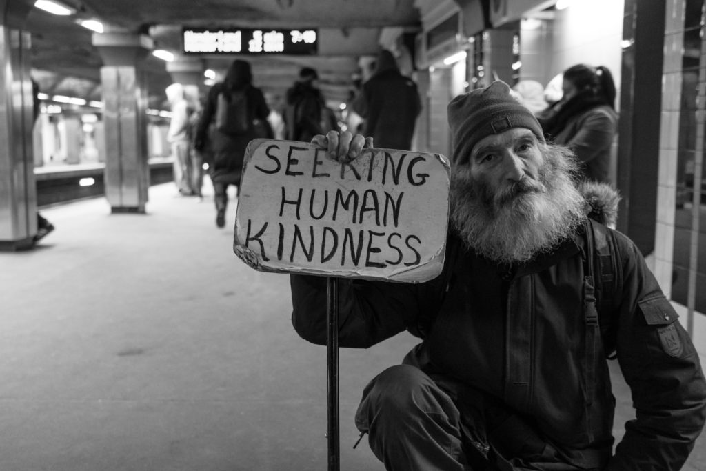 Image of a homeless person seeking kindness.